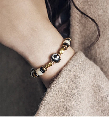 Bracelet de Prière Os Blanc Gravé et Intercalaires en Ébène – Œil Tibétain Protecteur