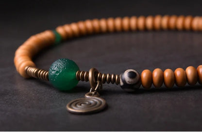 Bracelet Noyaux d'Olive et Onyx Vert avec Perle Œil de Bouddha – Tibétain Écologique