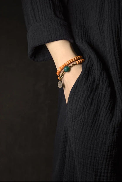 Bracelet Noyaux d'Olive et Onyx Vert avec Perle Œil de Bouddha – Tibétain Écologique