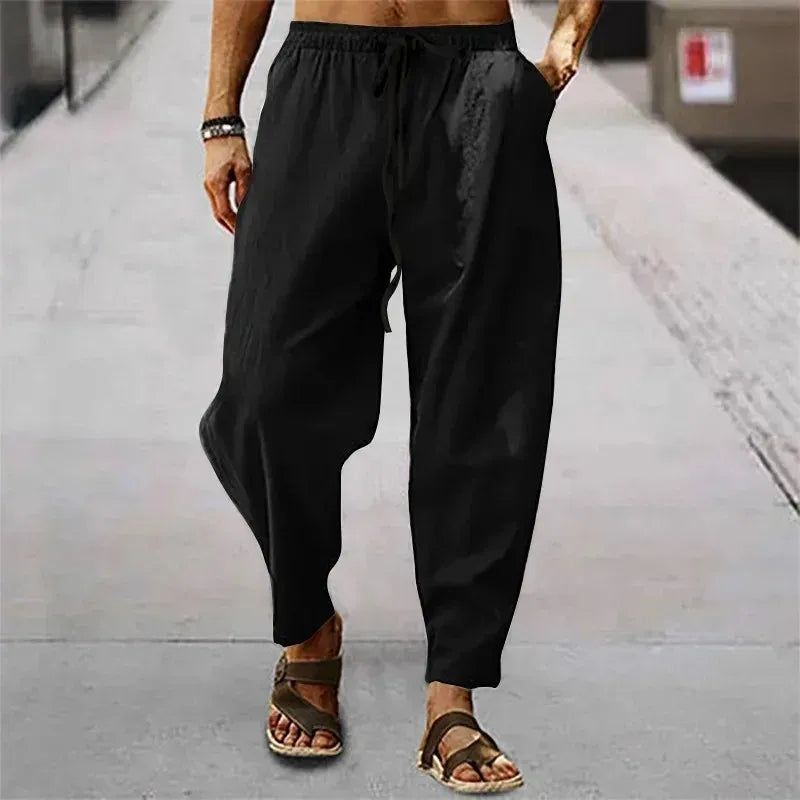 Pantalon zen noir en mélange lin, coupe sarouel moderne avec poches latérales et cordon.