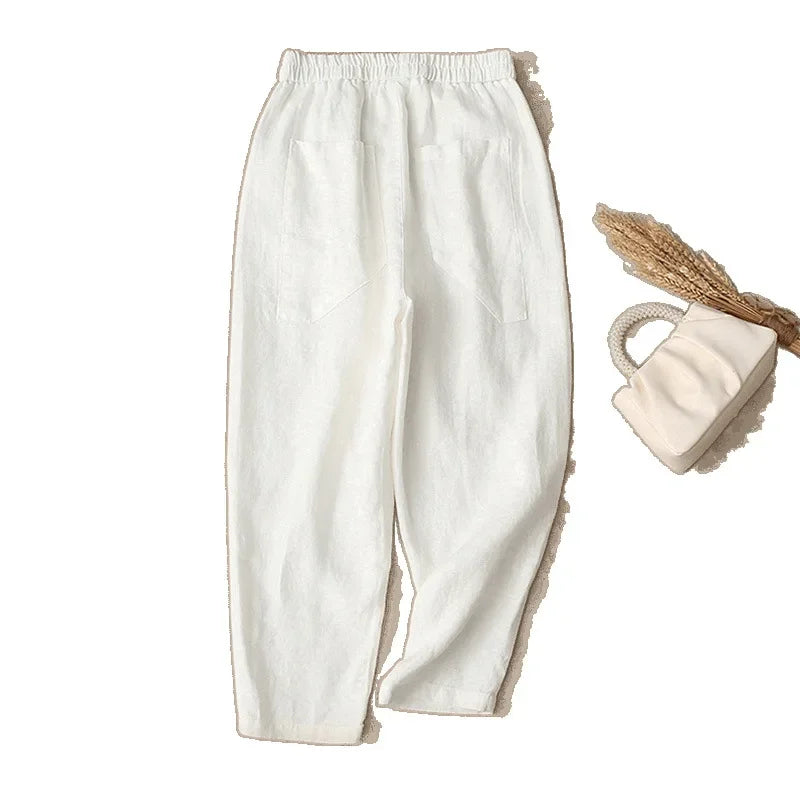 Vue de dos du pantalon harem blanc en coton, mettant en relief les deux grandes poches arrière carrées.