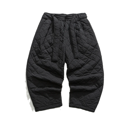 Pantalon sarouel matelassé noir pour homme, coupe ample et confortable avec surpiqûres.