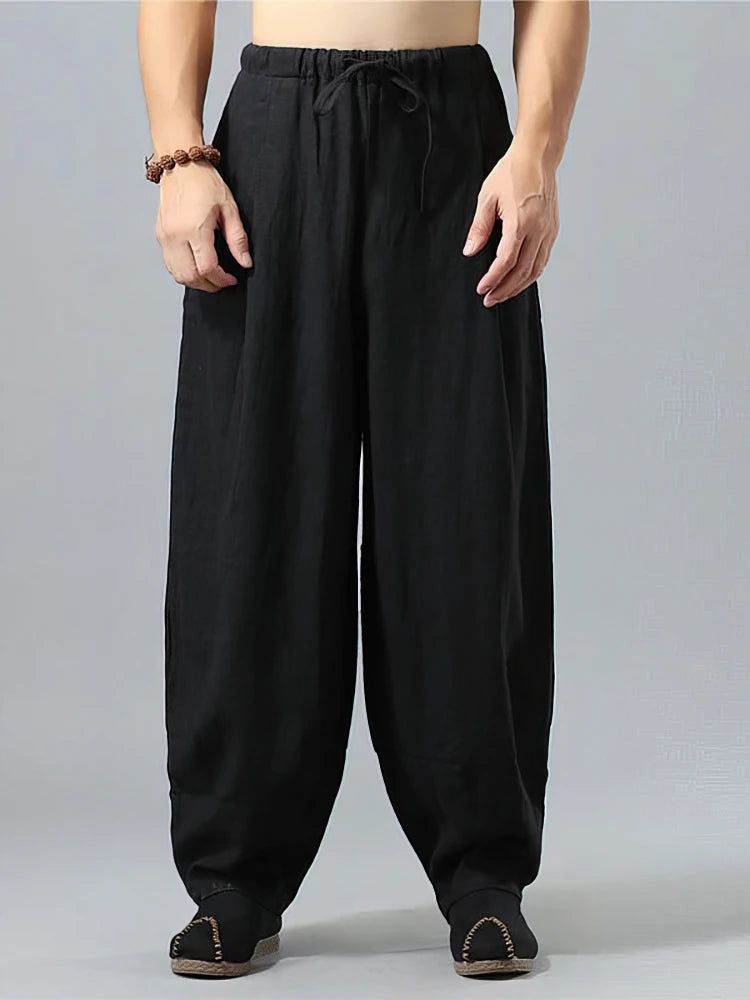 Pantalon large noir pour homme en tissu lin et coton, design minimaliste et confortable, vue de face.