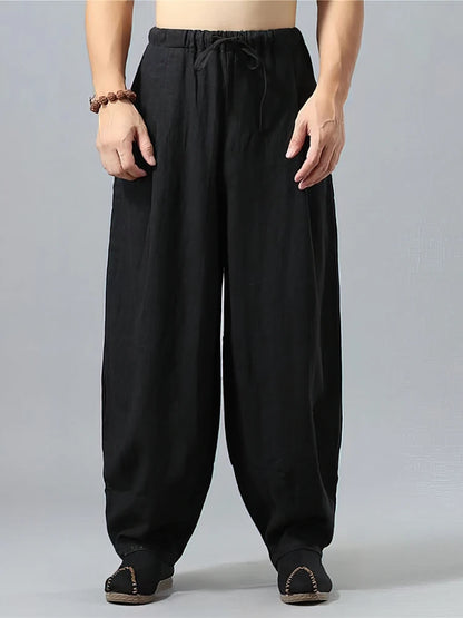 Pantalon large noir pour homme en tissu lin et coton, design minimaliste et confortable, vue de face.