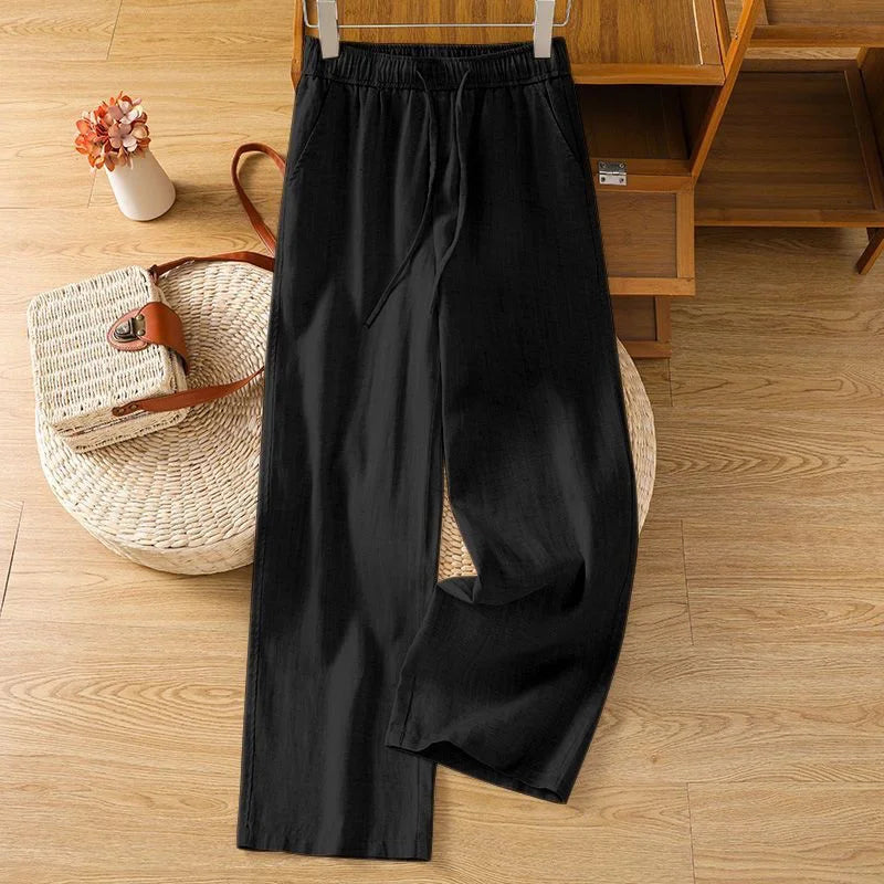 Pantalon fluide noir en lin mélangé, taille élastique avec cordon, style minimaliste et décontracté.