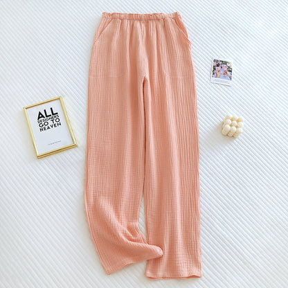Pantalon de pyjama fluide en coton crêpe couleur pêche, coupe droite et confortable.