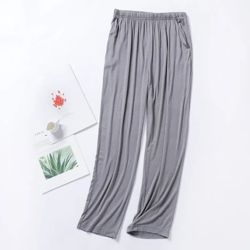 Pantalon de pyjama gris en modal fluide, coupe droite confortable avec taille élastiquée et poches.