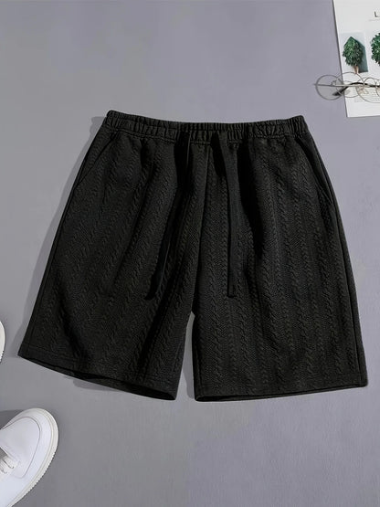 Vue à plat du short de détente noir en jacquard texturé, alliant style minimaliste et confort absolu.