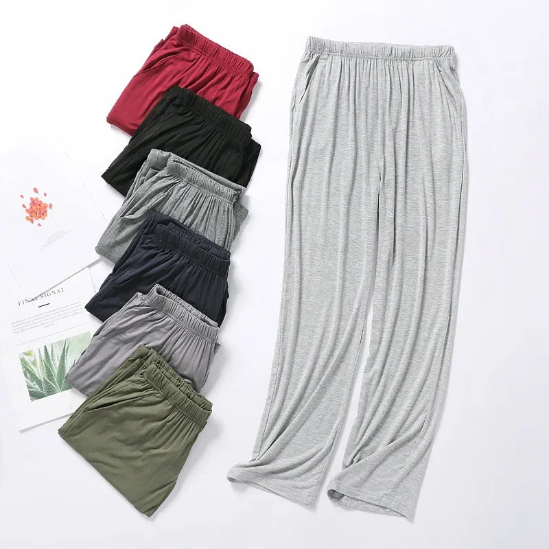 Sélection de pantalons de pyjama homme en modal déclinés en bleu marine, vert, bordeaux et gris chiné.