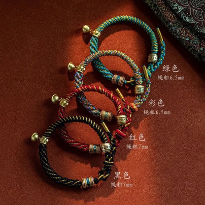 Détail artisanal des nœuds de protection et d'une perle en laiton sur le bracelet.
