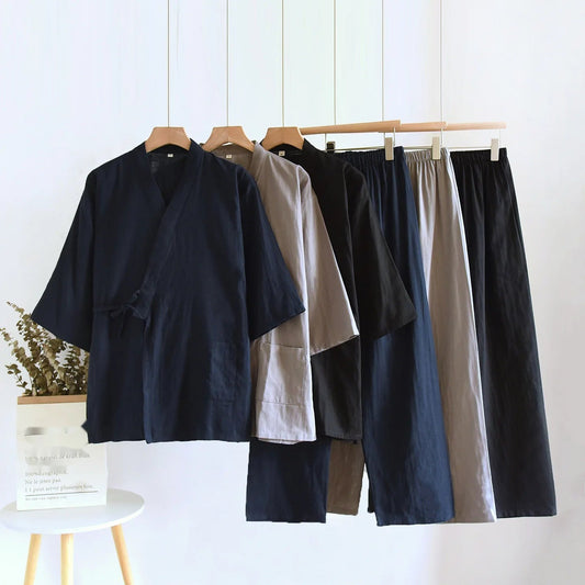 Ensemble pyjama kimono homme en coton suspendu sur cintres, décliné en bleu marine, gris et noir.